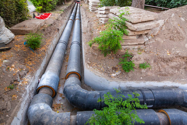 Laying new large diameter water pipes in the ground in the city.